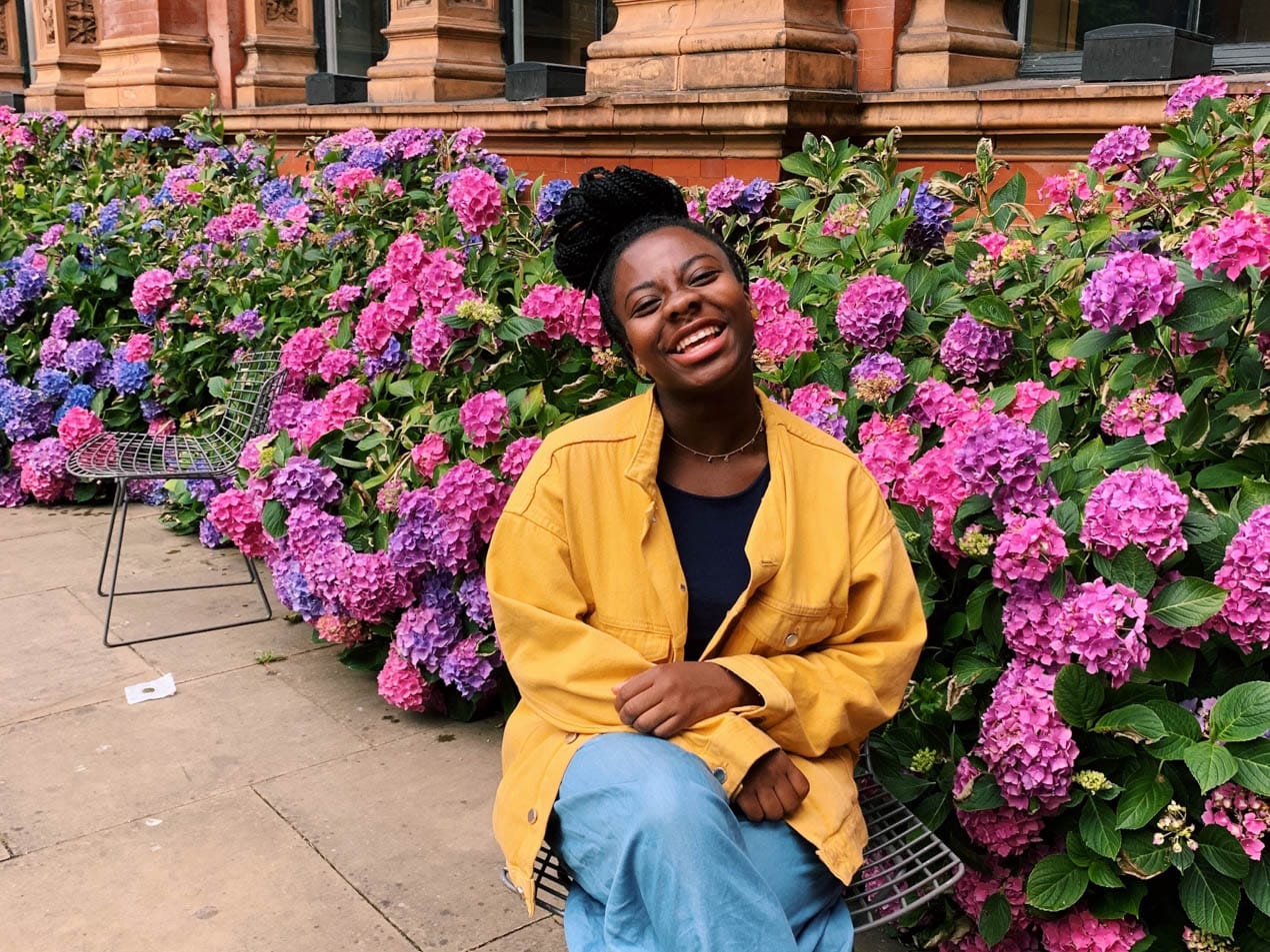 Saffiyah sitting by flowers